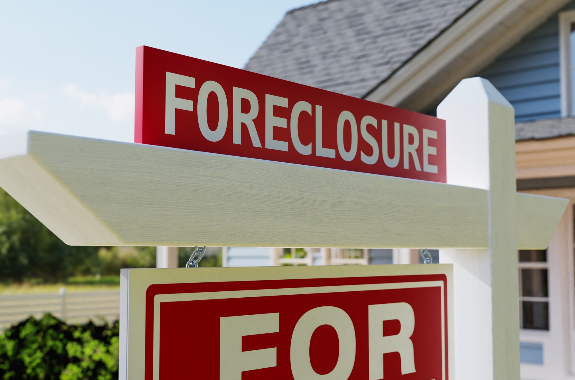 Foreclosure For Sale Real Estate Sign In Front of House.